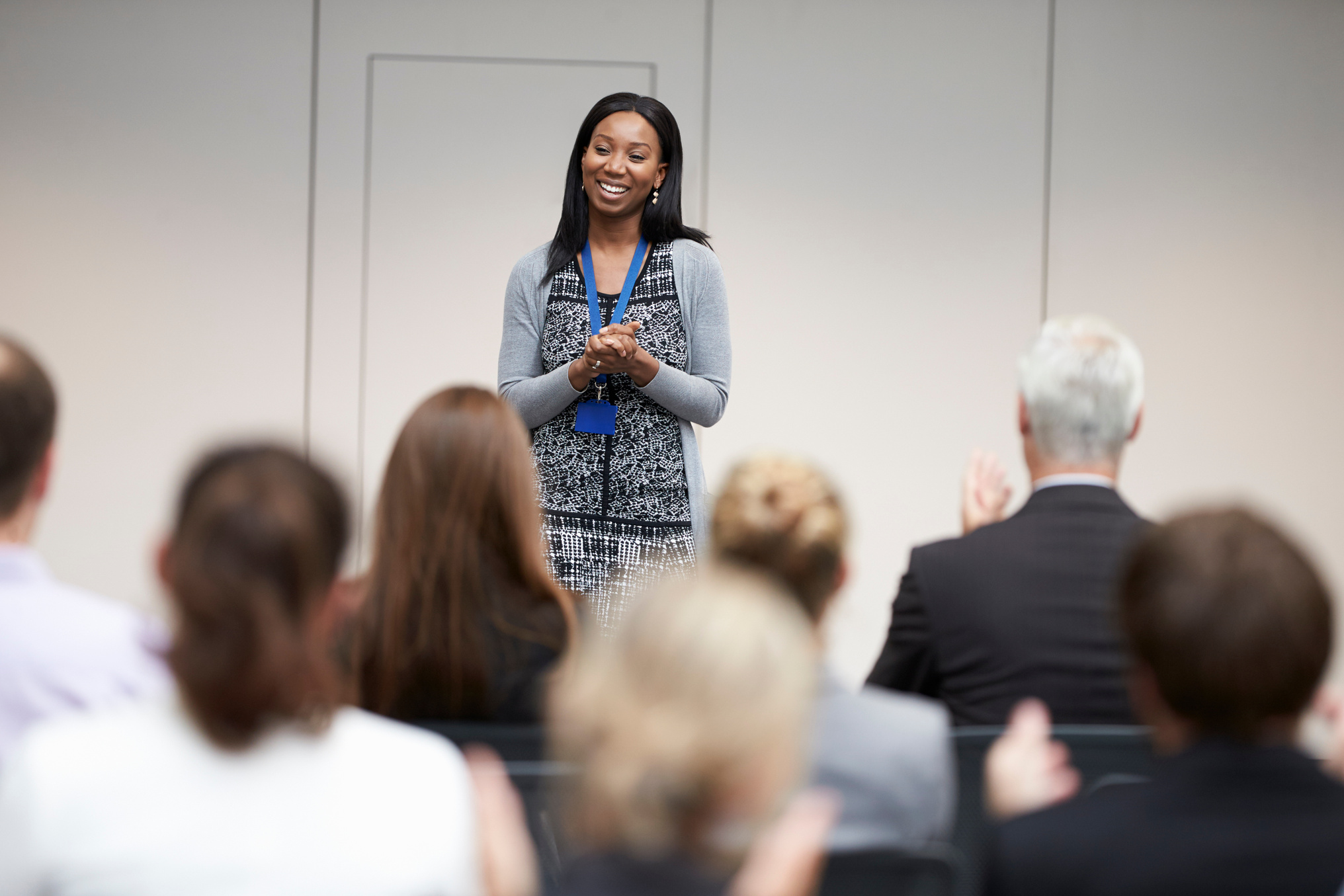 Audience Applauding the Female Speaker after Presentation